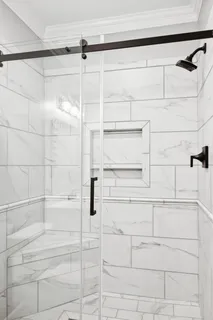 a kitchen with granite countertop white cabinets and stainless steel appliances