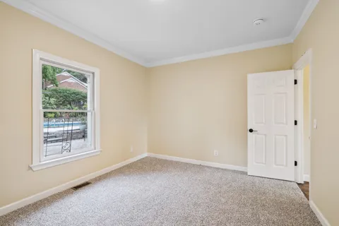 a kitchen with granite countertop white cabinets and stainless steel appliances