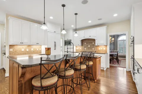 a dining room with furniture entryway and wooden floor
