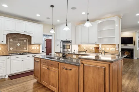 a view of staircase with wooden floor and white walls