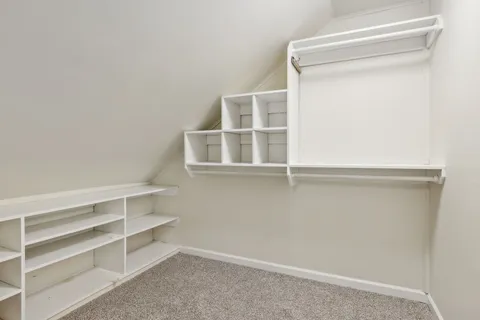 a view of bathroom with granite countertop white vanity and a mirror