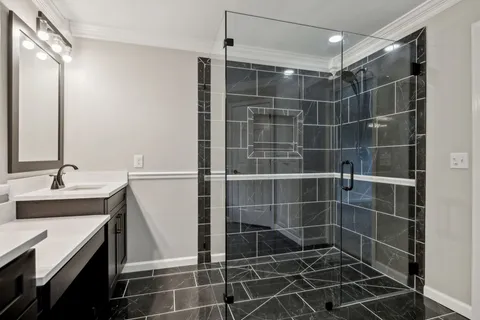 a kitchen with granite countertop a sink a stove and cabinets