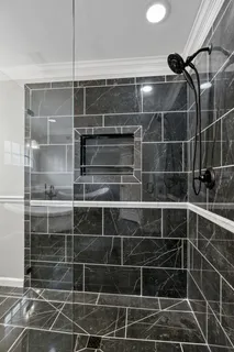 a kitchen with stainless steel appliances granite countertop a refrigerator sink and white cabinets