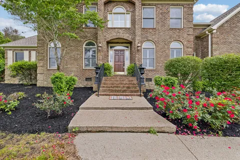 a view of a big room with wooden floor and windows
