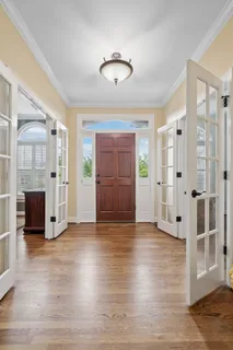 a view of a dining room with furniture and chandelier