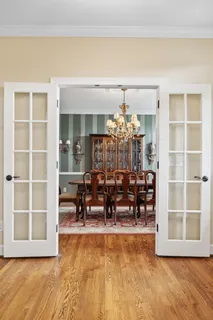 a view of a dining room with furniture wooden floor and chandelier