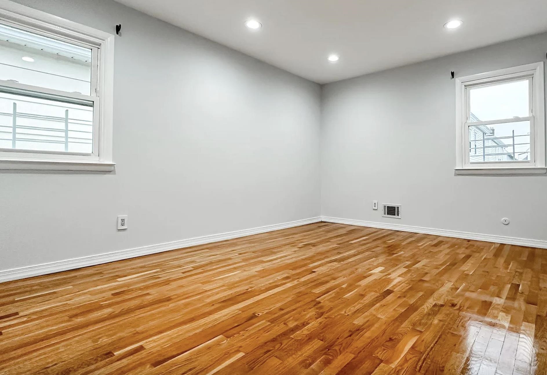 14 Centre Lane, Unit 2 Bayonne, NJ 07002 - Photo 11 of 21 a view of empty room with wooden floor and fan