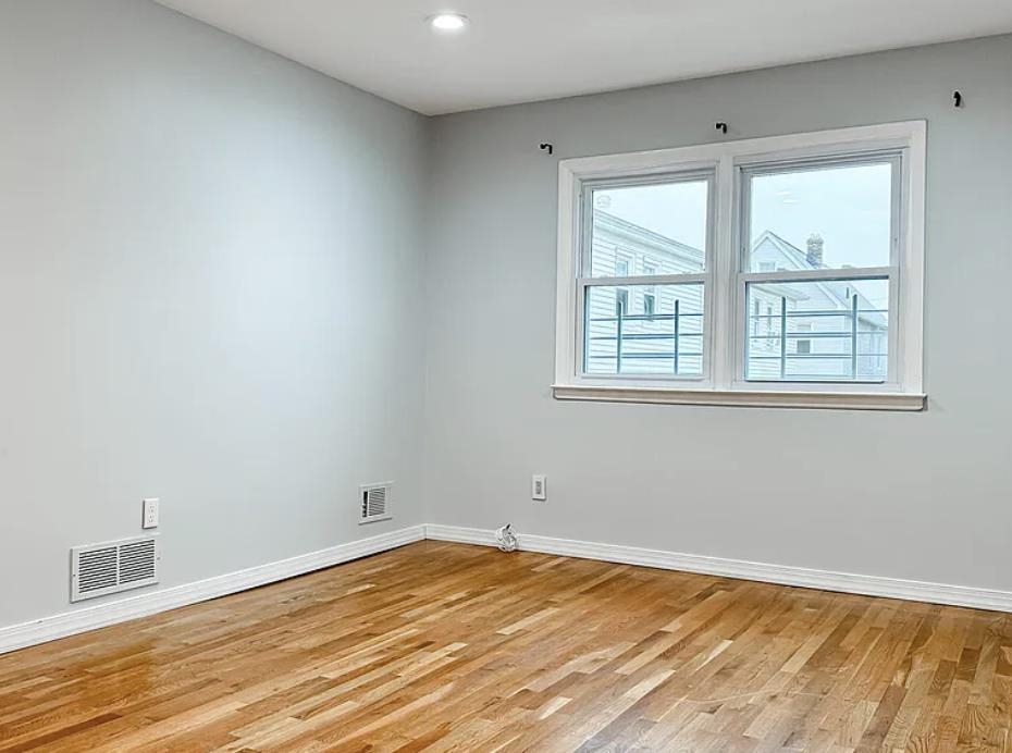 14 Centre Lane, Unit 2 Bayonne, NJ 07002 - Photo 16 of 21 a view of empty room with wooden floor and fan