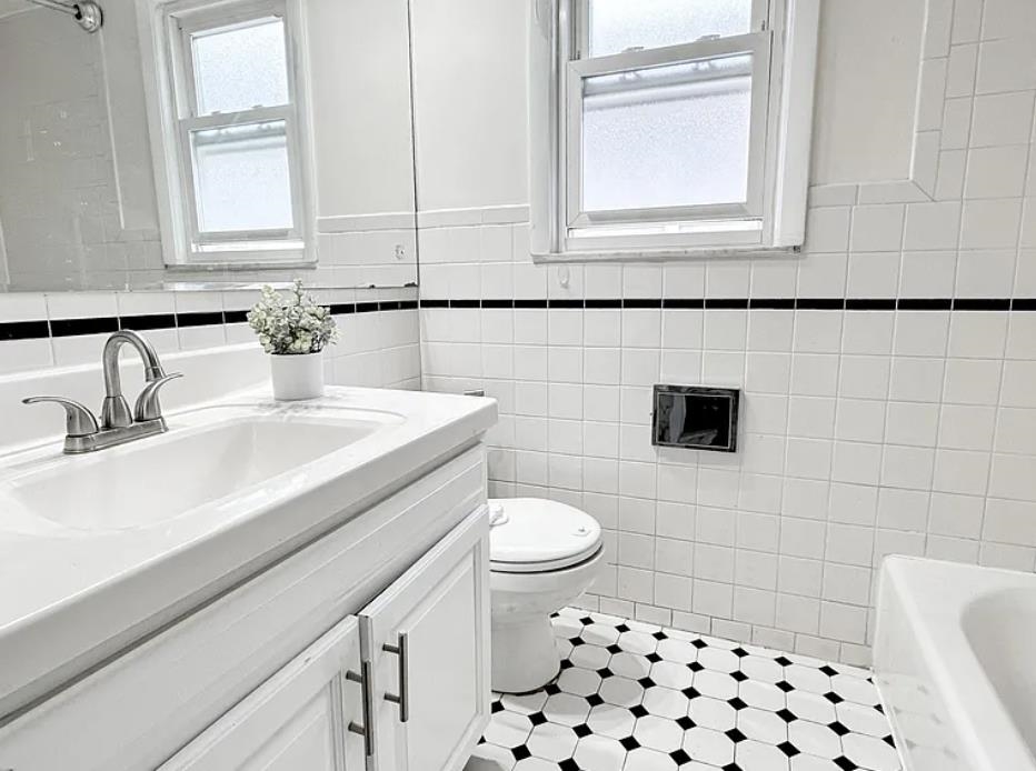 14 Centre Lane, Unit 2 Bayonne, NJ 07002 - Photo 18 of 21 a bathroom with a sink a toilet a mirror and shower