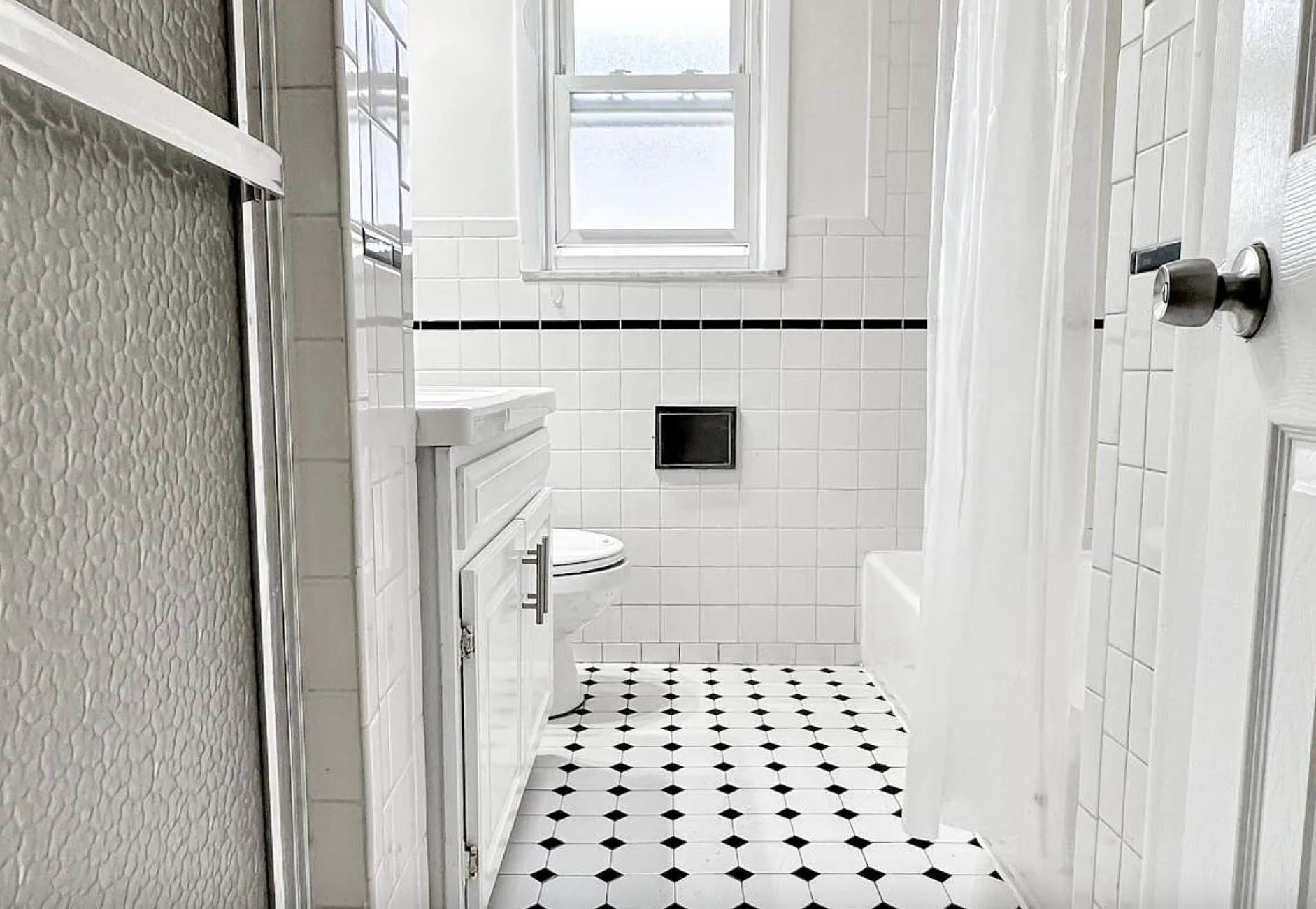 14 Centre Lane, Unit 2 Bayonne, NJ 07002 - Photo 19 of 21 a bathroom with a sink a toilet a window and shower