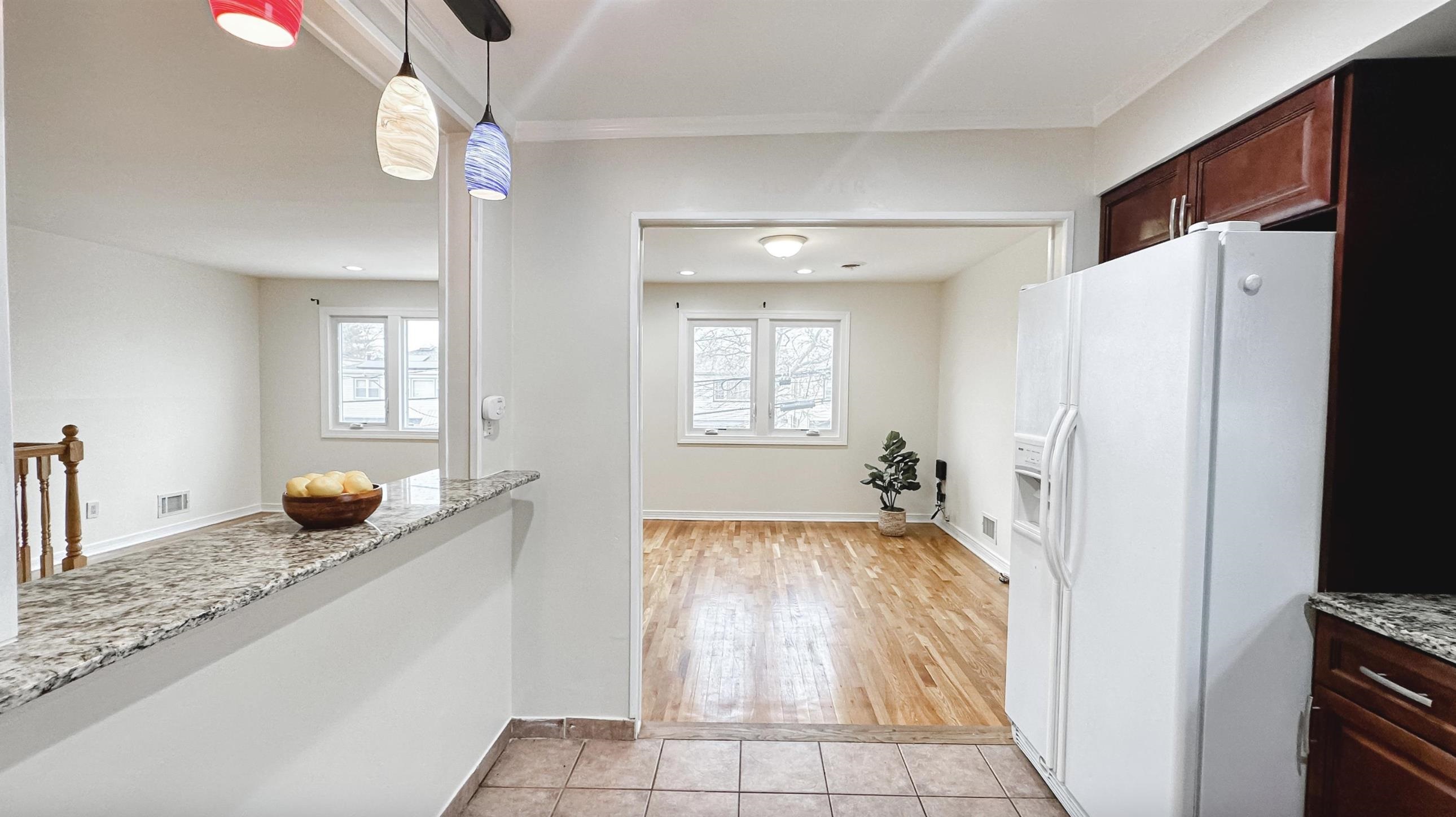 14 Centre Lane, Unit 2 Bayonne, NJ 07002 - Photo 3 of 21 a bedroom with a bed and a chandelier