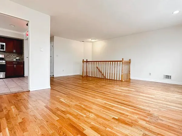 a view of a room with wooden floor