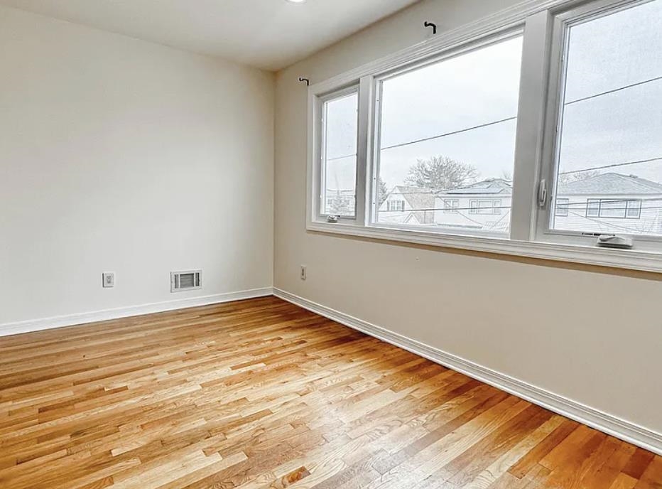 14 Centre Lane, Unit 2 Bayonne, NJ 07002 - Photo 6 of 21 a view of empty room with wooden floor and fan