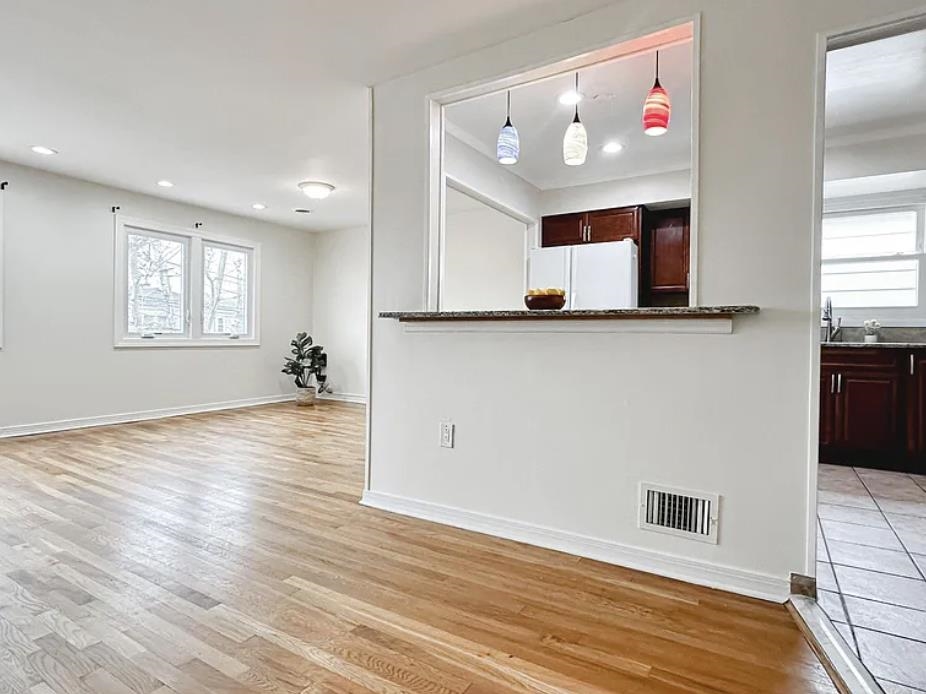 14 Centre Lane, Unit 2 Bayonne, NJ 07002 - Photo 7 of 21 a view of an empty room with window and wooden floor
