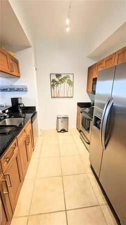 a kitchen with stainless steel appliances granite countertop a sink and cabinets