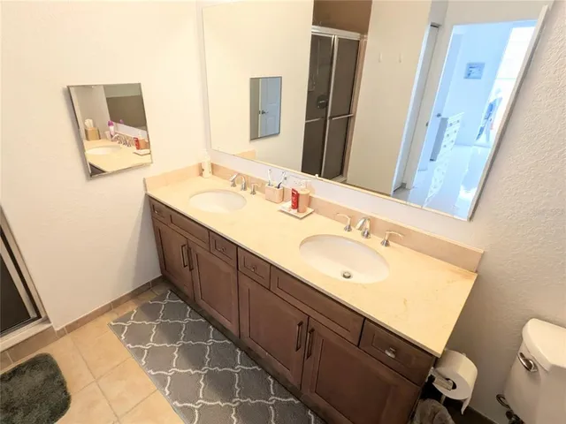 a spacious bathroom with a double vanity sink mirror and toilet