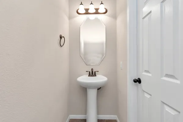 a bathroom with a sink a mirror and a window