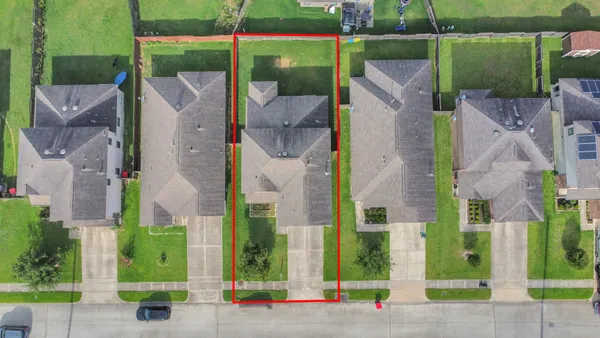 an aerial view of a house with a yard and plants