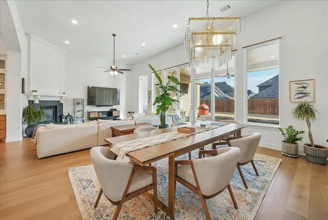 a view of a dining room with a table and chairs