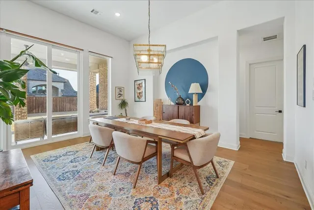 a large white kitchen with a stove a sink and a large window