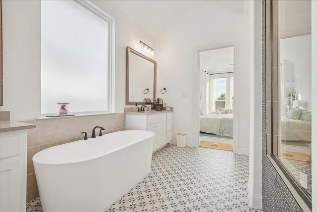 a bathroom with a tub and a shower