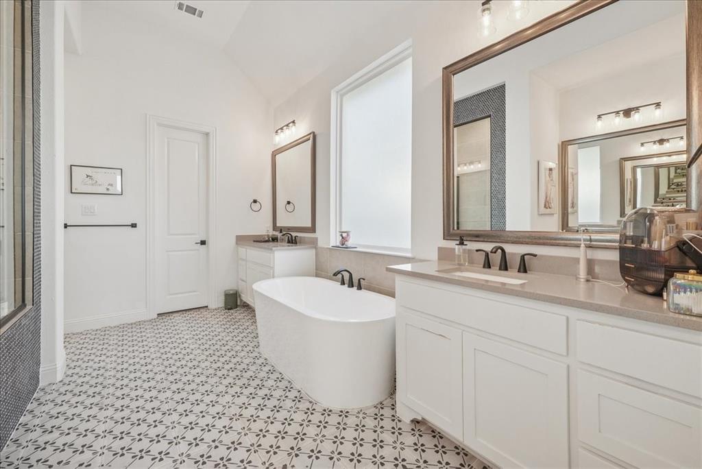 1981 Star Trace Parkway Prosper, TX 75078 - Photo 19 of 32 a bathroom with a sink a toilet and mirror