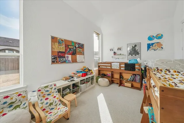 a children room with furniture and a couch