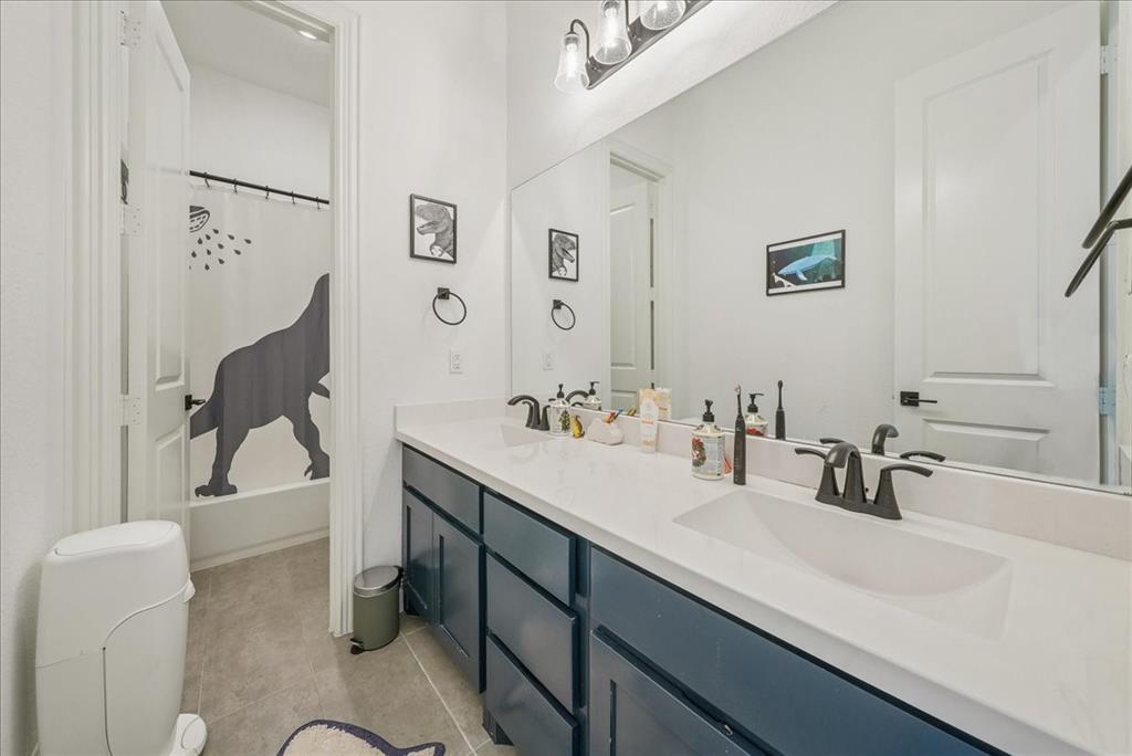 1981 Star Trace Parkway Prosper, TX 75078 - Photo 23 of 32 a bathroom with a sink and a mirror