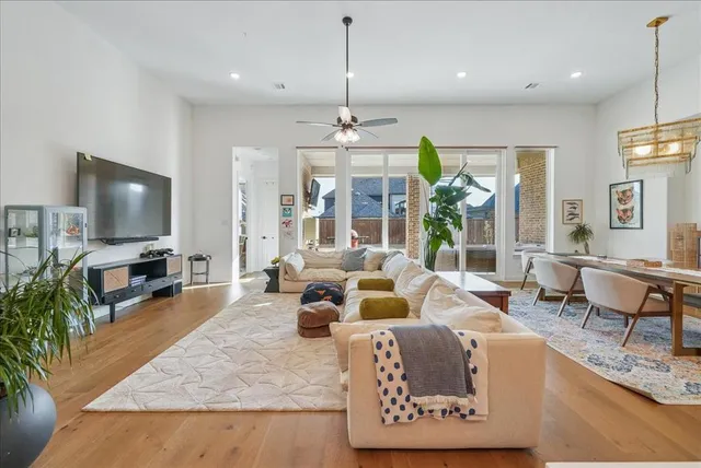 a living room with furniture a fireplace and a chandelier