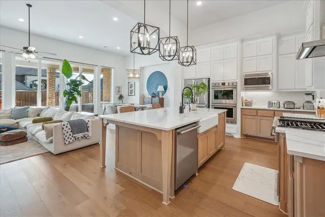 a kitchen with stainless steel appliances granite countertop a sink and cabinets