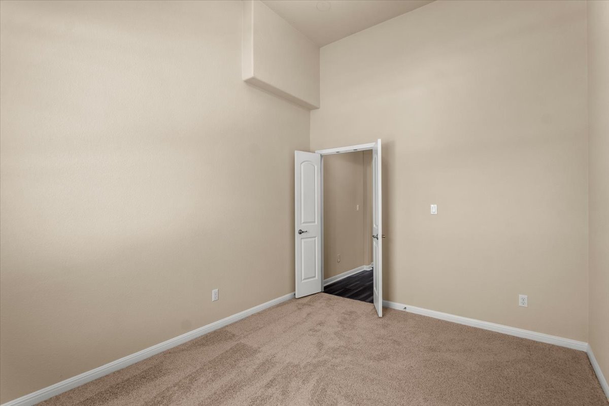 3451 Mayfield Ranch Boulevard, Unit 311 Round Rock, TX 78681 - Photo 15 of 40 Neutral tone walls with plush carpeting and white baseboards