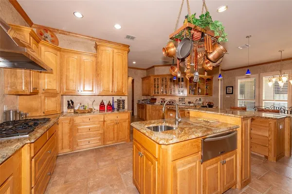 a kitchen with stainless steel appliances granite countertop a sink and cabinets