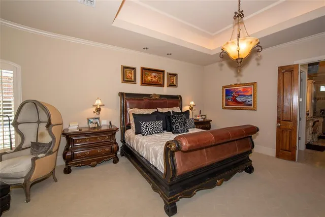 a spacious bedroom with a bed and a chandelier