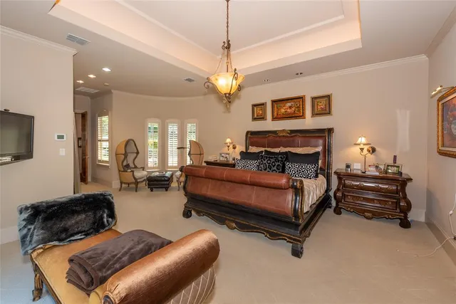 a living room with furniture a chandelier and a flat screen tv
