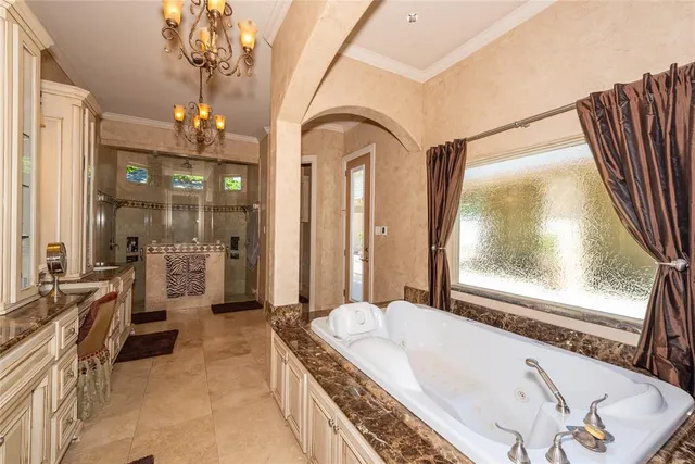 a spacious bathroom with a tub a double vanity sink and mirror