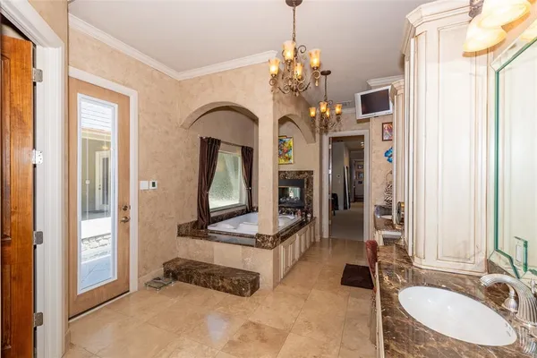 a bathroom with a sink a faucet a mirror and a bathtub