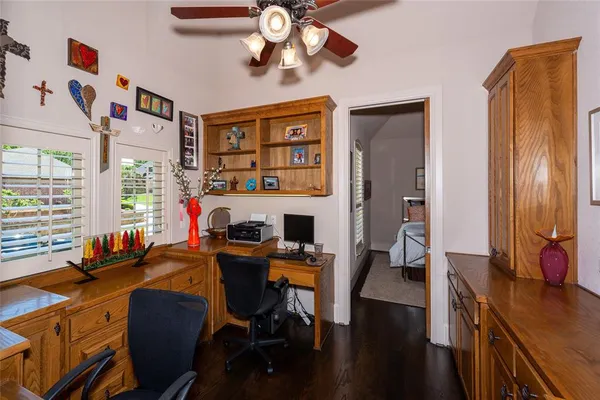 a view of a workspace with furniture and a window