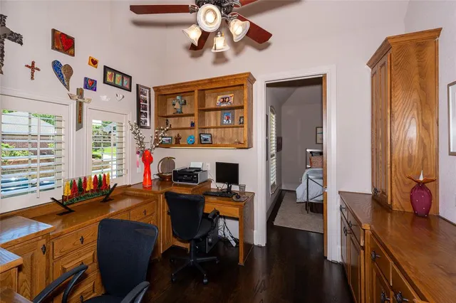 a view of a workspace with furniture and a window