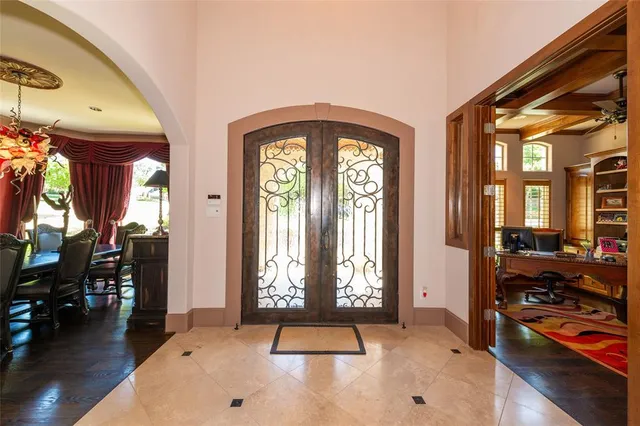 a bedroom with furniture and large windows