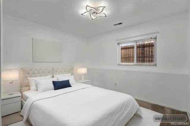 a bedroom with a bed and a potted plant