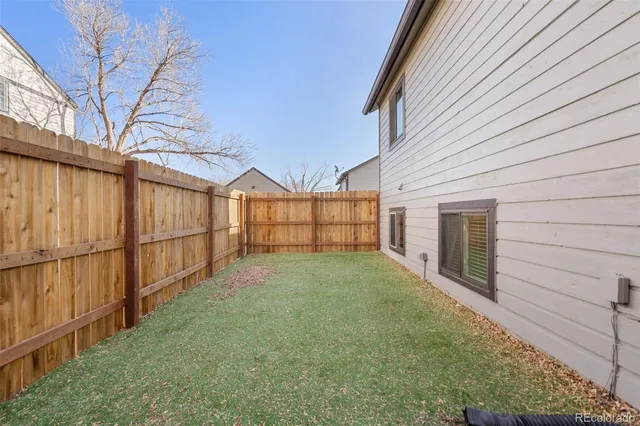 front view of a house with a yard and a garage