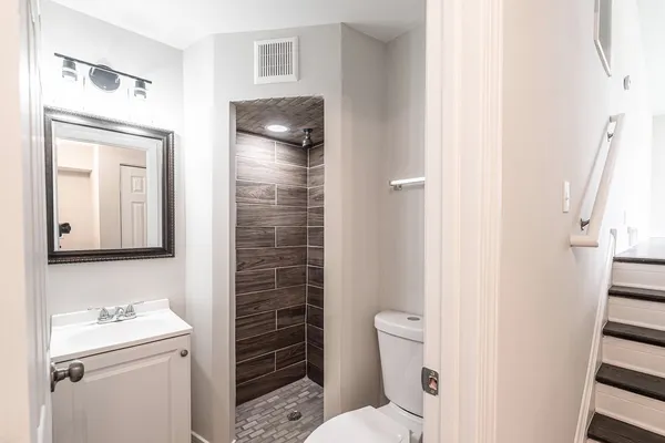 a bathroom with a toilet sink and a shower