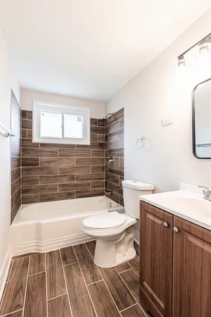 a bathroom with a toilet a sink and bathtub