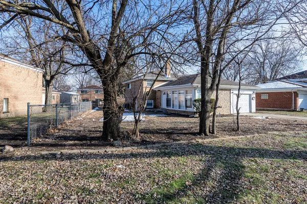 a large tree in front of a house