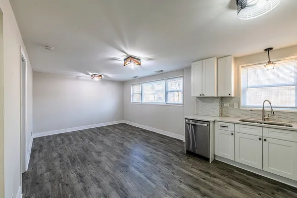 a kitchen with sink cabinets and window