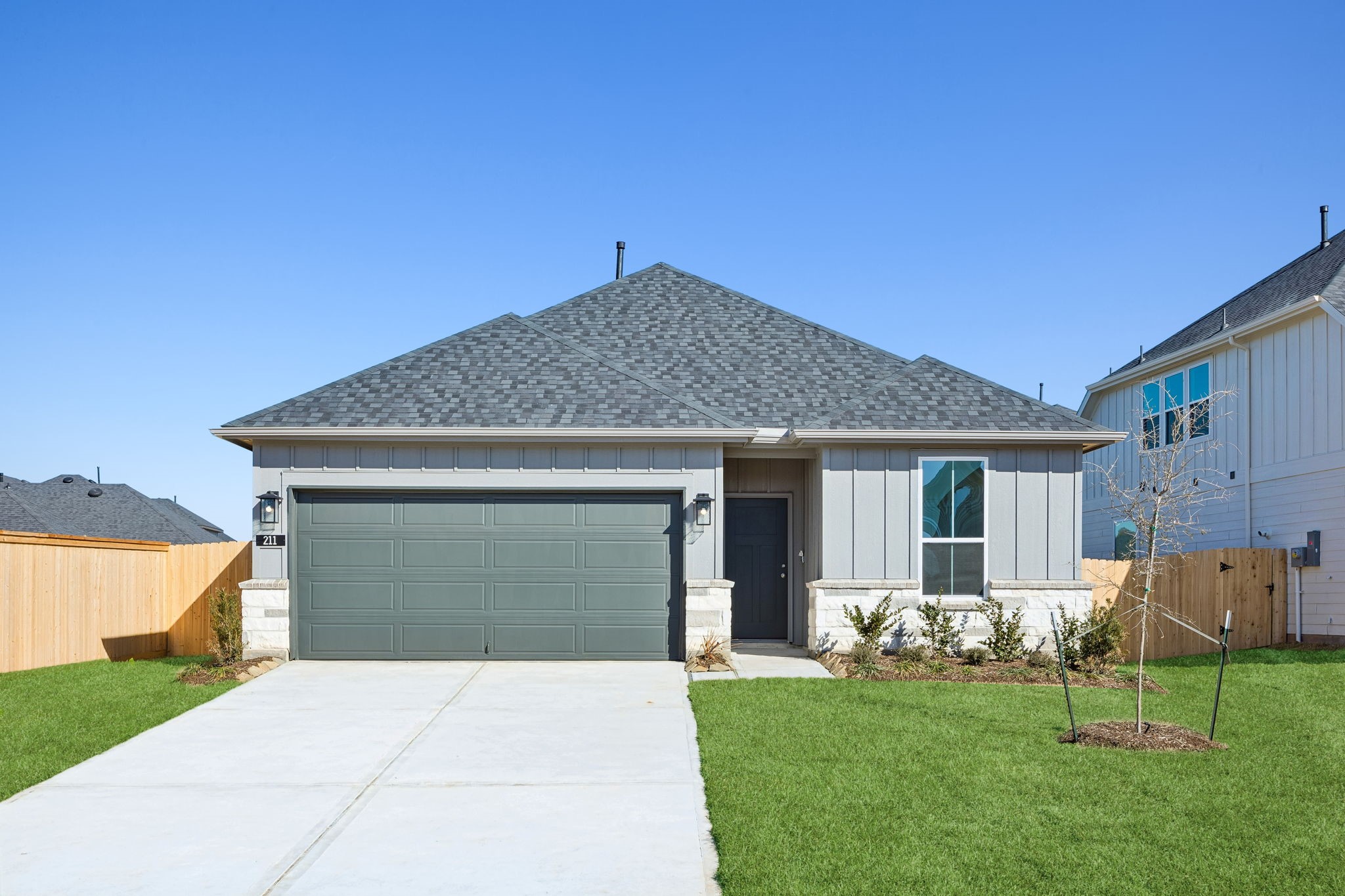 a front view of house with a garden