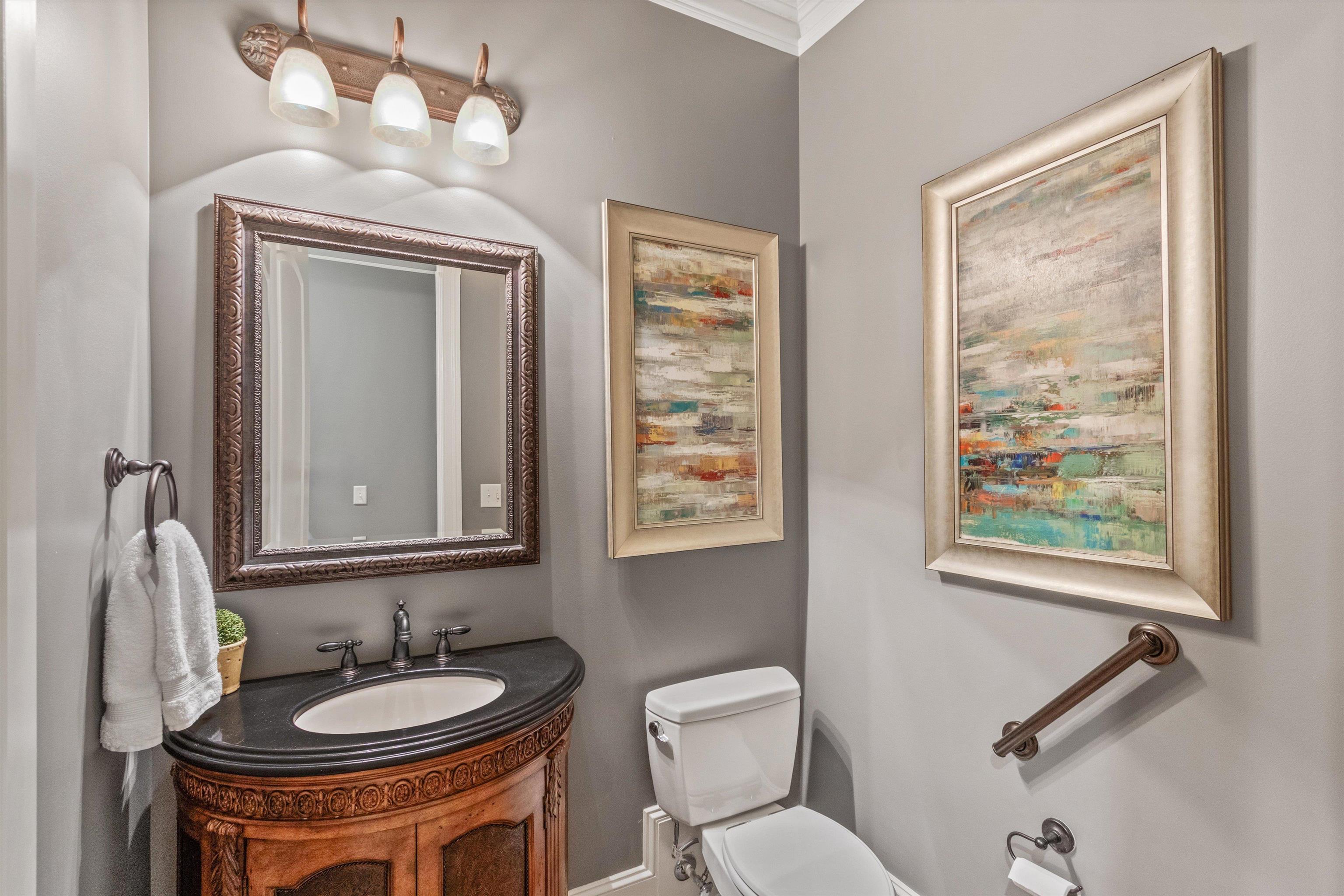 150 Ridgecrest Drive Arlington, TN 38002 - Photo 18 of 40 Powder room featuring a carved wood vanity with a dark countertop, an undermount sink, and an ornate framed mirror