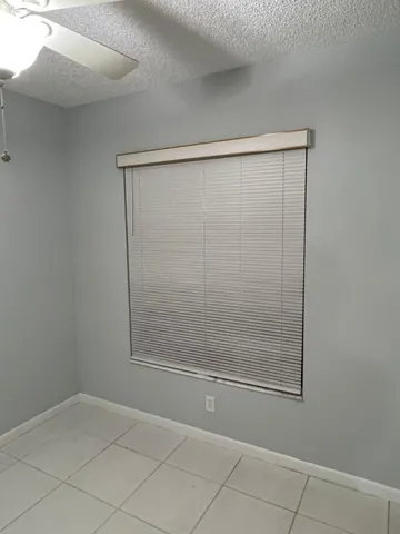 a view of a room with cabinet mirror and windows