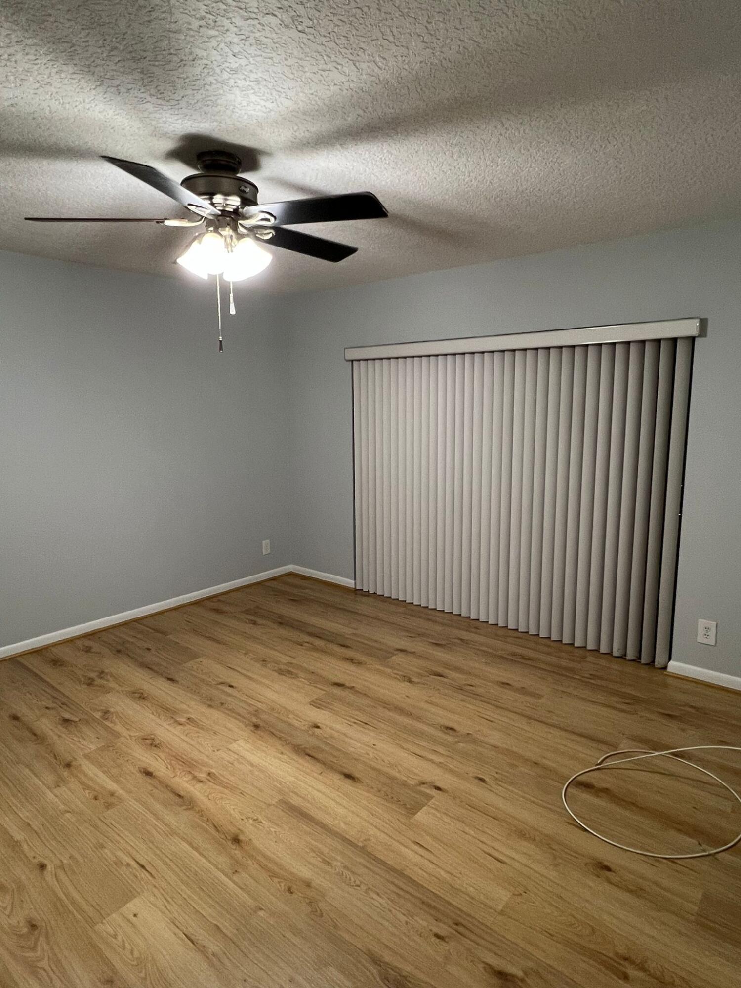 2335 Southwest 22nd Avenue, Unit 1030 Delray Beach, FL 33445 - Photo 14 of 41 a view of an empty room with wooden floor