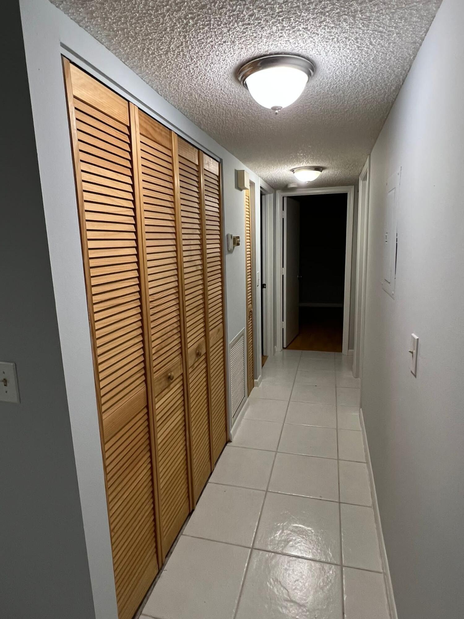 2335 Southwest 22nd Avenue, Unit 1030 Delray Beach, FL 33445 - Photo 17 of 41 a view of hallway with a sink and a large window